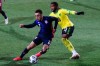 USA's Sergino Dest, left, duels for the ball with Jamaica's Kasey Palmer during the national anthem prior the international friendly soccer match between USA and Jamaica at SC Wiener Neustadt stadium in Wiener Neustadt, Austria, Thursday, March 25, 2021. (AP Photo/Ronald Zak)