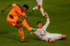 Valencia's Yunus Musah, left, kicks the ball next to Real Madrid's Casemiro during the Spanish La Liga soccer match between Real Madrid and Valencia at the Alfredo Di Stefano stadium in Madrid, Spain, Sunday, Feb. 14, 2021. (AP Photo/Manu Fernandez)