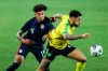 USA's Chris Richards, left, duels for the ball with Jamaica's Andre Gray during the international friendly soccer match between USA and Jamaica at SC Wiener Neustadt stadium in Wiener Neustadt, Austria, Thursday, March 25, 2021. (AP Photo/Ronald Zak)