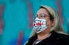 A Leipzig supporter wears a face mask to prevent the spread of the coronavirus prior the German Bundesliga soccer match between RB Leipzig and FC Schalke 04 in Leipzig, Germany, Saturday, Oct. 3, 2020. (AP Photo/Michael Sohn)