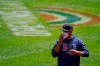 Boston Red Sox manager Alex Cora sends signs to third base coach third base coach Carlos Febles during the first inning of a baseball game against the Baltimore Orioles, Sunday, April 11, 2021, in Baltimore. (AP Photo/Julio Cortez)