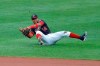 Washington Nationals second baseman Starlin Castro is unable to field a ground ball by Baltimore Orioles' Bryan Holaday during the sixth inning in the continuation of a suspended baseball game, Friday, Aug. 14, 2020, in Baltimore. The first part of the game was suspended on Aug. 9, when the groundskeepers had technical difficulties with the infield tarp in the sixth inning during a rain delay, causing the infield to become too wet and muddy to play. Orioles' Dwight Smith Jr. scored on the play. (AP Photo/Julio Cortez)