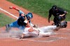 Baltimore Orioles Pat Valaika (74) is tagged out at home by Toronto Blue Jays catcher Reese McGuire (10) during the fourth inning of a baseball game, Wednesday, Aug. 19, 2020, in Baltimore. (AP Photo/Michael Owens)