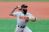 Baltimore Orioles relief pitcher Miguel Castro throws a pitch to the Washington Nationals during the seventh inning in the continuation of a suspended baseball game, Friday, Aug. 14, 2020, in Baltimore. The first part of the game was suspended on Aug. 9, when the groundskeepers had technical difficulties with the infield tarp in the sixth inning during a rain delay, causing the infield to become too wet and muddy to play. (AP Photo/Julio Cortez)