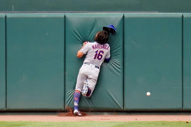 New York Mets center fielder Jake Marisnick smashes into the center field wall while chasing a triple by Baltimore Orioles' Pedro Severino during the second inning of a baseball game, Wednesday, Sept. 2, 2020, in Baltimore. (AP Photo/Julio Cortez)