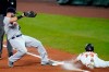 Boston Red Sox first baseman Mitch Moreland, left, steps on the bag while Baltimore Orioles' Andrew Velazquez makes a head first slide while trying to beat a ground out during the fifth inning of a baseball game, Thursday, Aug. 20, 2020, in Baltimore. (AP Photo/Julio Cortez)