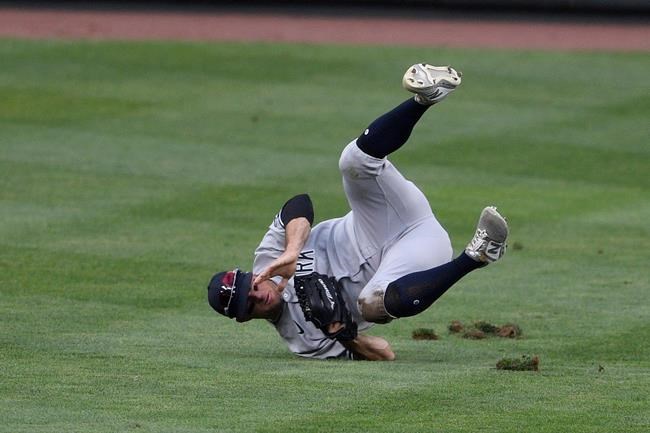 New York Yankees center fielder Brett Gardner tumbles after he made a sliding catch on a line drive by Baltimore Orioles' Anthony Santander for the out during the fifth inning of the first baseball game of a doubleheader, Friday, Sept. 4, 2020, in Baltimore. The Yankees won 6-5 in nine innings. (AP Photo/Nick Wass)
