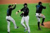 Miami Marlins' Brian Anderson, center, Eddy Alvarez, left, and Jonathan Villar (2) celebrate after a baseball game against the Baltimore Orioles, Thursday, Aug. 6, 2020, in Baltimore. (AP Photo/Nick Wass)