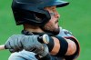 The Olympic rings are seen on the knob of Miami Marlins' Eddy Alvarez's bat as he swings at a pitch from the Baltimore Orioles during the seventh inning in the first game of a baseball doubleheader, Wednesday, Aug. 5, 2020, in Baltimore. Among the Marlins' roster replacements following their coronavirus outbreak was infielder Alvarez, a 2014 Olympic silver medalist in speedskating. And now at 30 he has made his major league debut. (AP Photo/Julio Cortez)