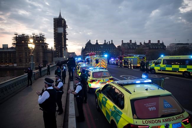 FILE - In this Thursday, April 16, 2020 file photo London Ambulance staff, police officers and firefighters take part in the weekly