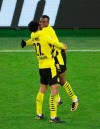 Dortmund's Youssoufa Moukoko, right, celebrates scoring his goal with Jude Bellingham, left, during the German Bundesliga soccer match between Dortmund and Berlin Hertha, in Dortmund, Germany, Saturday, March 13, 2021. (Friedemann Vogel/Pool Photo via AP)