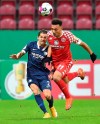 Mainz's Karim Onisiwo, right, competes for the ball with Bochum's Cristian Gamboa, during the German Cup 2nd round soccer match between FSV Mainz 05 and VfL Bochum at the Opel Arena, in Mainz, Germany, Wednesday, Dec. 23, 2020. (Torsten Silz/dpa via AP)