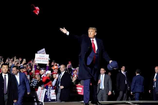 U.S. President Donald Trump throws hats to supporters after speaking at a campaign rally at Duluth International Airport in Duluth, Minn., on Wednesday. (AP Photo/Alex Brandon, File)