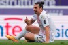 Milan's Zlatan Ibrahimovic sits on the grass during the Italian Serie A soccer match between Bologna and Milan at the Renato Dall'Ara stadium in Bologna, Italy, Saturday, Jan. 30, 2021. (Spada/LaPresse via AP)