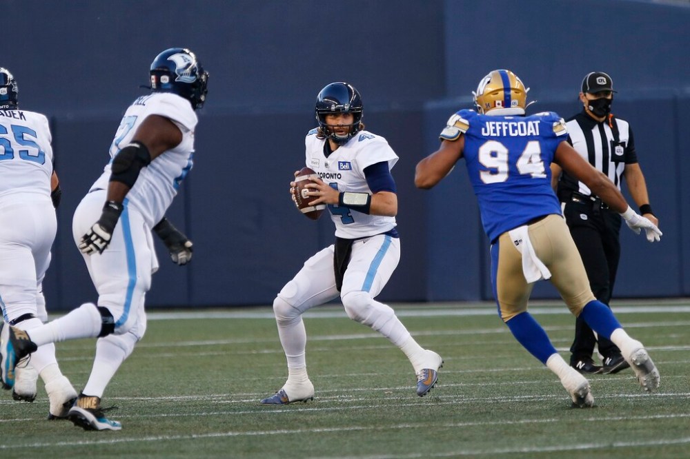 Winnipeg Blue Bombers' Jackson Jeffcoat pressures Toronto Argonauts quarterback McLeod Bethel-Thompson during the first half. THE CANADIAN PRESS/John Woods