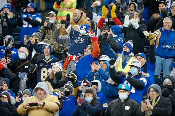 THE CANADIAN PRESS/John WoodsWinnipeg Blue Bombers and fans celebrate the team's Grey Cup in Winnipeg on Wednesday.