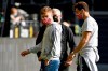 Munich's Joshua Kimmich, front left, and Munich's Leon Goretzka, front right, walk on the pitch prior to the German Bundesliga soccer match between Borussia Dortmund in FC Bayern Munich in Dortmund, Germany, Tuesday, May 26, 2020. The German Bundesliga is the world's first major soccer league to resume after a two-month suspension because of the coronavirus pandemic. (Federico Gambarini/DPA via AP, Pool)