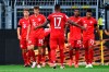 Munich's scorer Joshua Kimmich, left, and his teammates celebrate the opening goal during the German Bundesliga soccer match between Borussia Dortmund and FC Bayern Munich in Dortmund, Germany, Tuesday, May 26, 2020. The German Bundesliga is the world's first major soccer league to resume after a two-month suspension because of the coronavirus pandemic. (Federico Gambarini/DPA via AP, Pool)