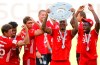Munich's Jerome Boateng lifts the trophy after the German Bundesliga soccer match between VfL Wolfsburg and FC Bayern Munich in Wolfsburg, Germany, Saturday, June 27, 2020. Bayern wins the 8th straight Bundesliga title. (Kai Pfaffenbach/Pool Photo via AP)