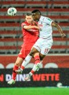 Leverkusen's Sven Bender, left, and Cologne's Jhon Cordoba, right, go for a header during the German Bundesliga soccer match between Bayer 04 Leverkusen and 1. FC Cologne in Leverkusen, Germany, Wednesday, June 17, 2020.(Ina Fassbender/Pool Photo via AP)