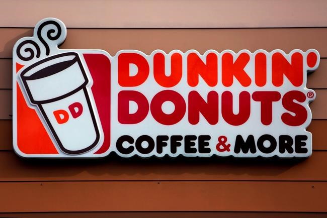 FILE - This Jan. 22, 2018, file photo shows a Dunkin' Donuts logo on a shop in Mount Lebanon, Pa. The Massachusetts-based coffee and donuts empire is teaming with Post Consumer Brands to release two new breakfast cereals based on two of its most popular coffee drinks: Caramel Macchiato and Mocha Latte. The new cereals are expected to hit grocery shelves in late August 2020. (AP Photo/Gene J. Puskar, File)