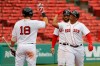 Boston Red Sox's Rafael Devers is congratulated by Mitch Moreland (18) after his two-run home run against the Philadelphia Phillies during the third inning of a baseball game Wednesday, Aug. 19, 2020, at Fenway Park in Boston. (AP Photo/Winslow Townson)