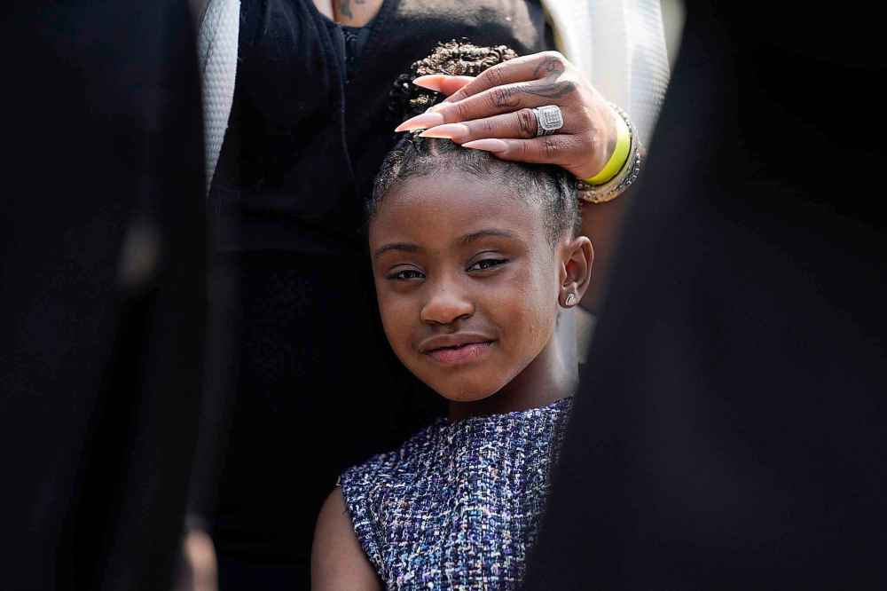 Gianna Floyd, the daughter of George Floyd, listens as family members speak to reporters after meeting with President Joe Biden at the White House, Tuesday, May 25, 2021, in Washington. (AP Photo/Evan Vucci)