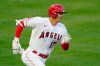 Los Angeles Angels designated hitter Shohei Ohtani (17) runs to first after hitting a triple in the first inning of an MLB baseball game against the Chicago White Sox Friday, April 2, 2021, in Anaheim, Calif. (AP Photo/Ashley Landis)