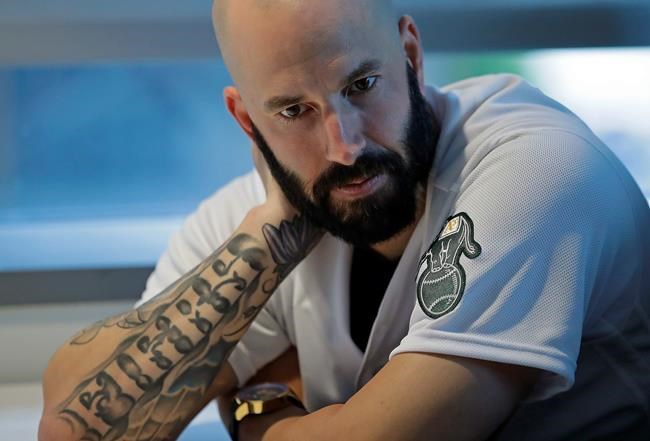 Oakland Athletics pitcher Mike Fiers ponders a question during an interview with the media on Friday, Jan. 24, 2020, in Oakland, Calif. Fiers, the Oakland pitcher and whistleblower in the Houston Astros sign-stealing scandal, appeared with teammates and manager Bob Melvin at team offices. Fiers has not spoken publicly about the sign stealing since the story was published in The Athletic in November. (AP Photo/Ben Margot)