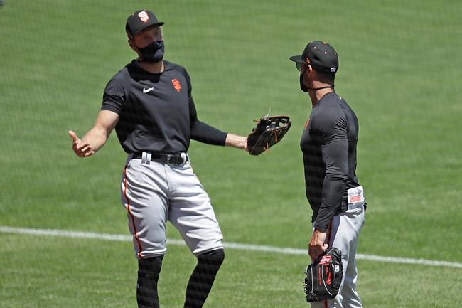 San Francisco Giants' Hunter Pence, left, gestures while speaking with manager Gabe Kapler during a baseball practice Friday, July 10, 2020, in San Francisco. (AP Photo/Ben Margot)
