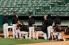 Some San Francisco Giants kneel during the national anthem prior to an exhibition baseball game against the Oakland Athletics on Monday, July 20, 2020, in Oakland, Calif. (AP Photo/Ben Margot)