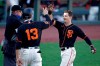 San Francisco Giants' Mike Yastrzemski, right, celebrates with Austin Slater (13) after the two scored during the fourth inning of a baseball game against the Oakland Athletics on Saturday, Aug. 15, 2020, in San Francisco. Yastrzemski tripled, and scored on a throwing error by Athletics' Marcus Semien. (AP Photo/Ben Margot)