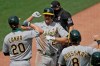 Oakland Athletics' Stephen Piscotty, center, celebrates with Mark Canha (20) and Robbie Grossman (8) after hitting a three-run home run off San Francisco Giants' Dereck Rodriguez in the fifth inning of a baseball game Sunday, Aug. 16, 2020, in San Francisco. (AP Photo/Ben Margot)