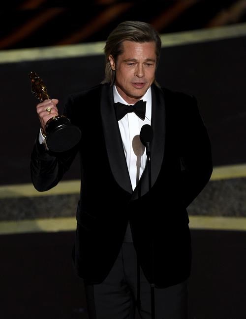 Brad Pitt accepts the award for best performance by an actor in a supporting role for