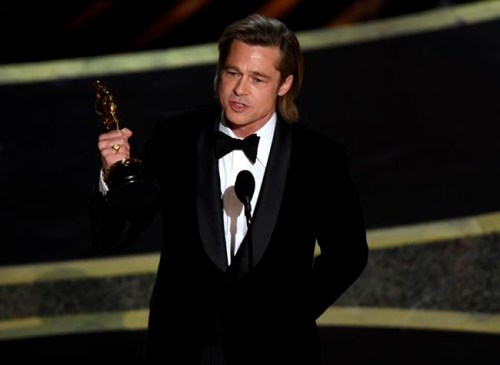 Brad Pitt accepts the award for best performance by an actor in a supporting role for 
