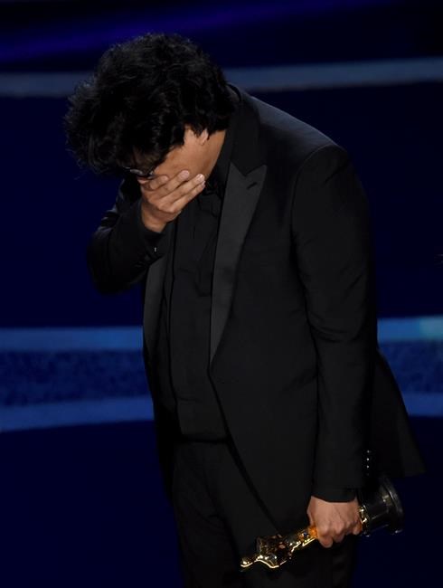 Bong Joon Ho reacts as he accepts the award for best director for