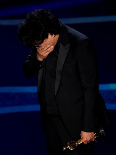 Bong Joon Ho reacts as he accepts the award for best director for 