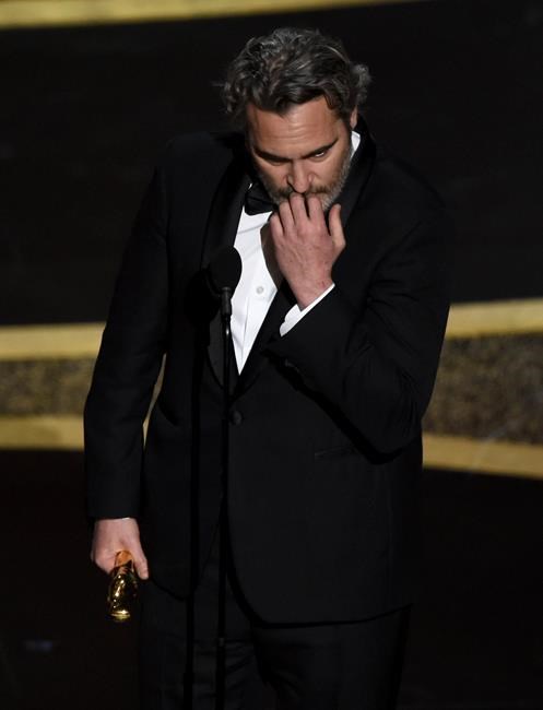 Joaquin Phoenix reacts as he accepts the award for best performance by an actor in a leading role for