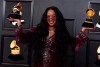 H.E.R. poses in the press room with the award for song of the year for 