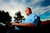 In Nov. 7, 2013, Dan Walters, a former Police Officer who was paralyzed in 2003 after being shot in the neck, sits in his wheelchair on his back porch at home in the College area of San Diego. Walters, a former San Diego Padres catcher-turned-police officer who was paralyzed in a 2003 shooting, died Thursday, April 23, 2020, the police union said. He was 53. (San Diego Union-Tribune via AP)