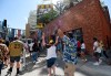 Baseball fans celebrate as the gates open up before a baseball game between the Arizona Diamondbacks and the San Diego Padres Thursday, April 1, 2021, on opening day in San Diego. (AP Photo/Denis Poroy)