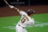 San Diego Padres' Manny Machado hits a two-run home run during the fourth inning of a baseball game against the Seattle Mariners, Friday, Sept. 18, 2020, in San Diego. (AP Photo/Denis Poroy)