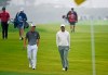 Collin Morikawa, left foreground, talks with Tiger Woods as they walk on the fourth hole of the South Course at Torrey Pines Golf Course during the second round of the Farmers Insurance golf tournament Friday Jan. 24, 2020, in San Diego. (AP Photo/Denis Poroy)