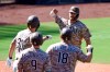 San Diego Padres' Wil Myers (4) is congratulated by Eric Hosmer (30), Jake Cronenworth (9) and Mitch Moreland (18) after hitting a three-run home run during the sixth inning of a baseball game against the Seattle Mariners Sunday, Sept. 20, 2020, in San Diego. (AP Photo/Denis Poroy)