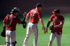Arizona Diamondbacks catche Carson Kelly, left, Chris Devenski and David Peralta high-five after the Diamondbacks beat the San Diego Padres 3-1 in a baseball game Sunday, April 4, 2021, in San Diego. (AP Photo/Denis Poroy)