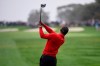Tiger Woods hits his tee shot on the fourth hole of the South Course at Torrey Pines Golf Course during the final round of the Farmers Insurance golf tournament Sunday Jan. 26, 2020, in San Diego. (AP Photo/Denis Poroy)