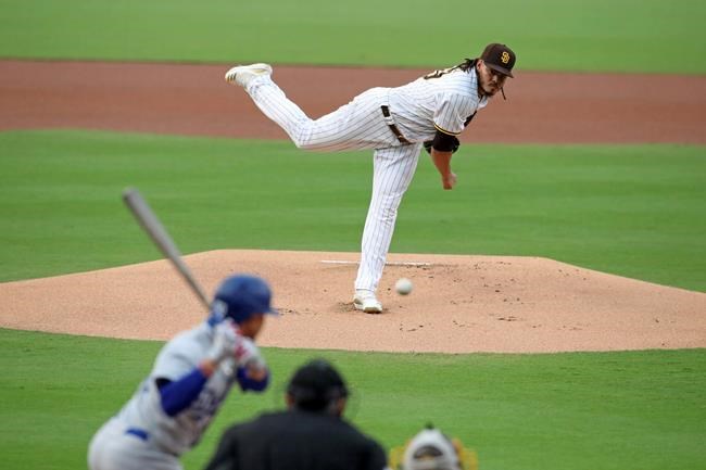 San Diego Padres starting pitcher Dinelson Lamet, top, delivers to Los Angeles Dodgers' Mookie Betts in the first inning of a baseball game Monday, Sept. 14, 2020, in San Diego. (AP Photo/Derrick Tuskan)