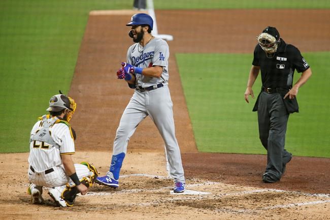 Los Angeles Dodgers' Edwin Rios reacts as he crosses home plate after hitting a solo home run against the San Diego Padres starting pitcher Zach Davies in the fifth inning of a baseball game Tuesday, Sept. 15, 2020, in San Diego. (AP Photo/Derrick Tuskan)