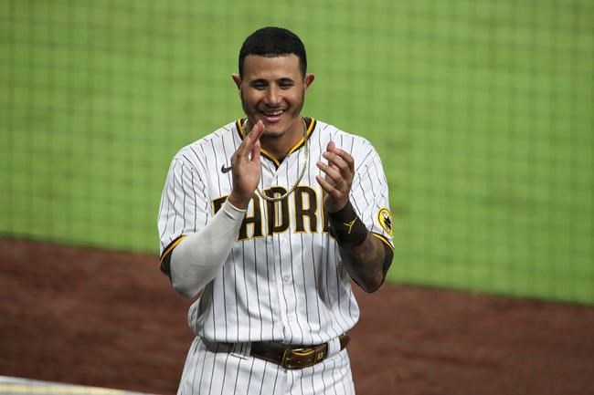 San Diego Padres' Manny Machado reacts after the Padres score against the Los Angeles Dodgers in the seventh inning of a baseball game, Monday, Sept. 14, 2020, in San Diego. (AP Photo/Derrick Tuskan)