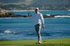 Nick Taylor, of Canada, reacts on the 18th green of the Pebble Beach Golf Links after winning the AT&T Pebble Beach National Pro-Am golf tournament Sunday, Feb. 9, 2020, in Pebble Beach, Calif. (AP Photo/Eric Risberg)